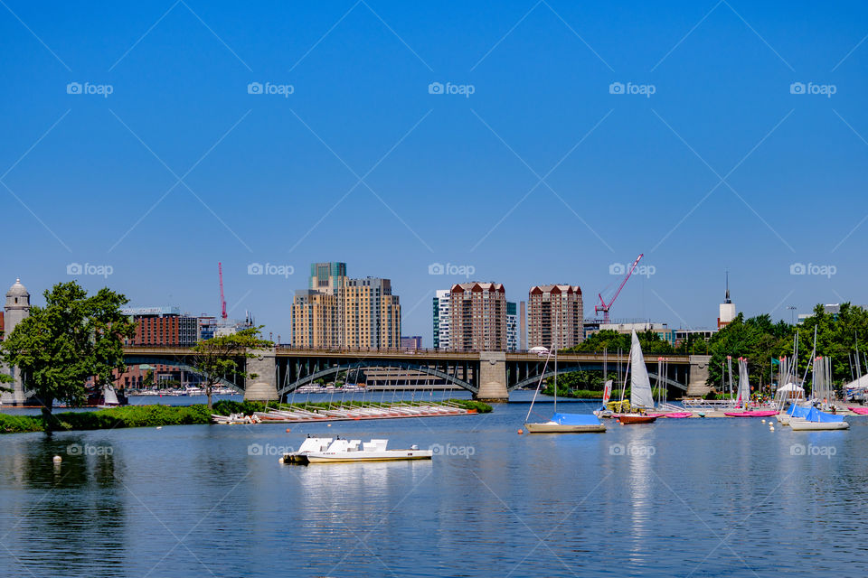 Boats, bridges, and sails in front of the architectures of boston