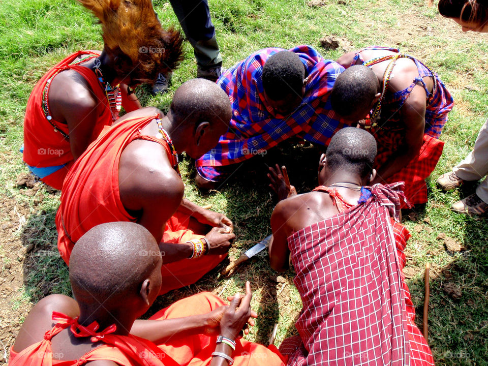Maasai men making fire