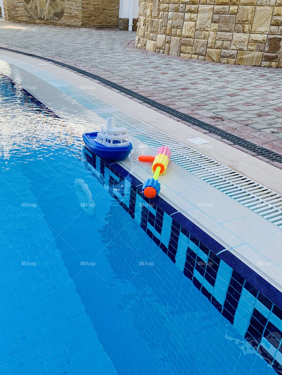 Forgotten pool toys: boat and water gun