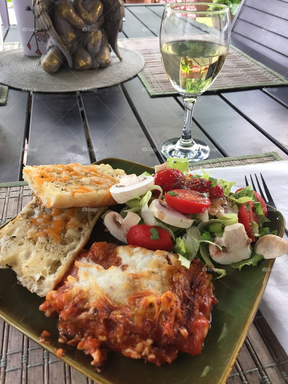 Lasagna with garlic bread and romaine salad