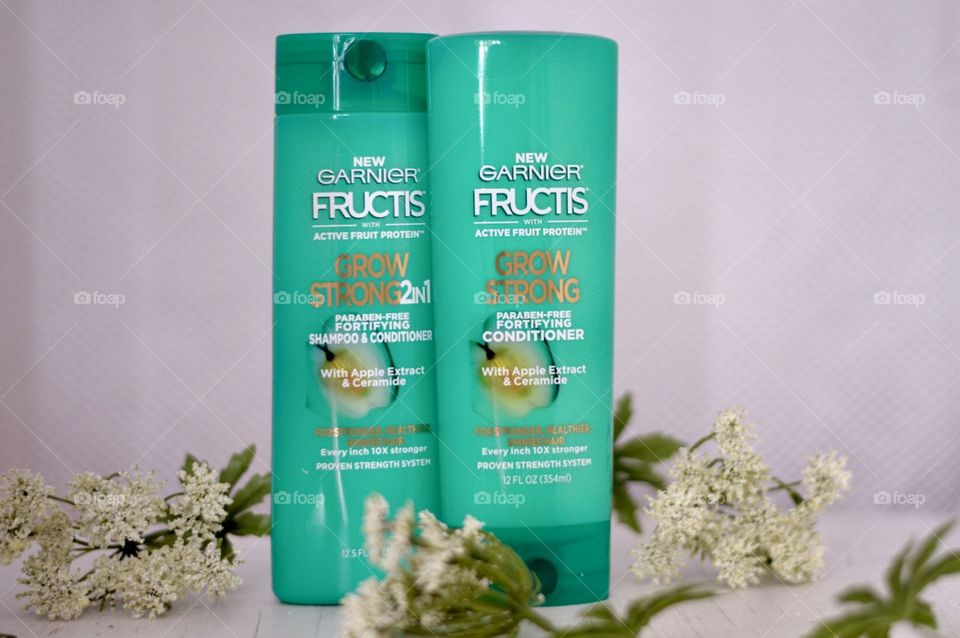 Garnier grow strong conditioner and shampoo Flat lay on a white background