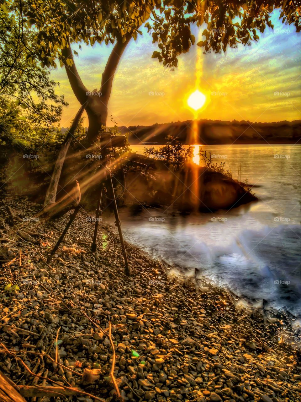 Photography on the river. A sunset on the river with my tripod in the background. 