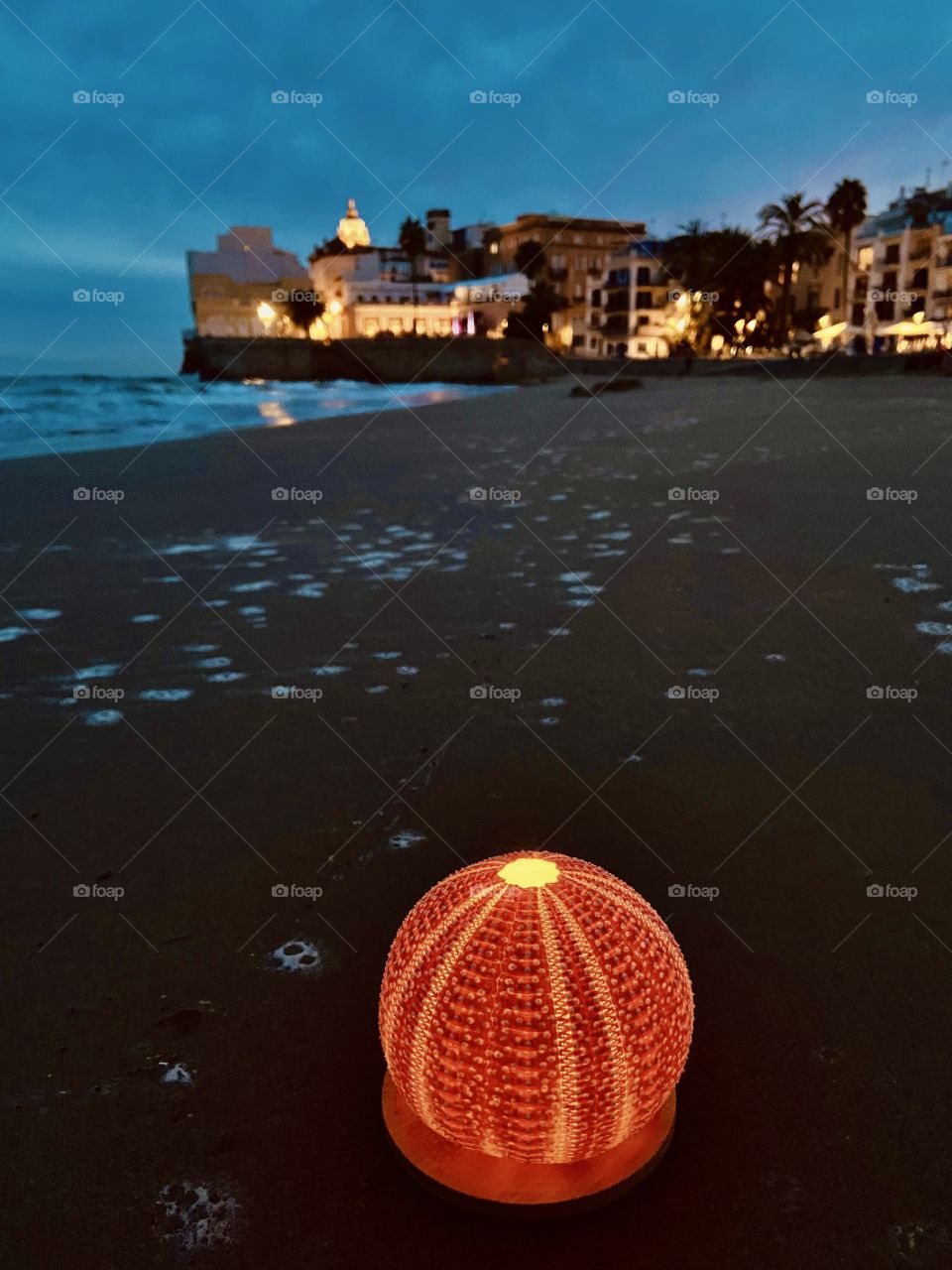 A Lofotlys from the Lofoten islands on a Spanish beach in Sitges. Lofotlys are sea urchins converted into lamps. In the Lofoten, sea urchins eat kelp, reducing the oxygen levels in the sea. 