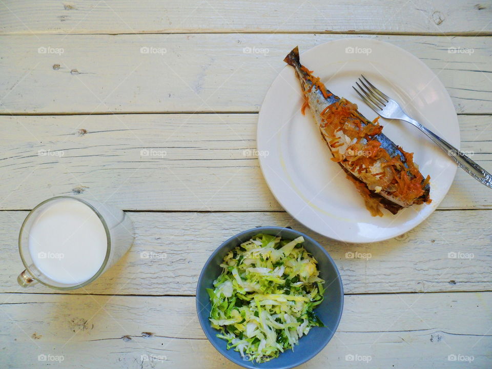 baked mackerel, vegetable salad and a cup of milk, breakfast