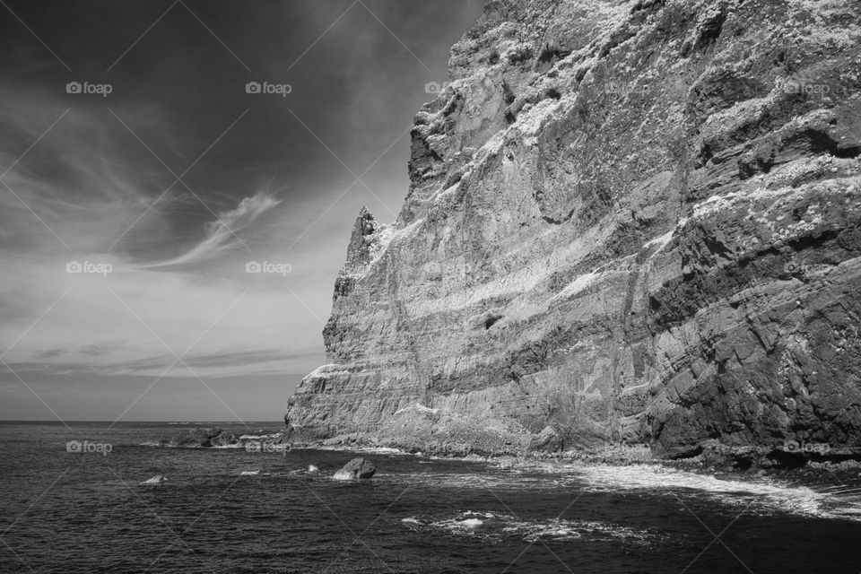 A black and white image of a jagged cliff face on the island of Madeira during spring 
