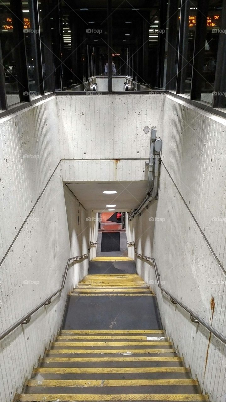 Train Station Stairwell with Man Sleeping on Landing