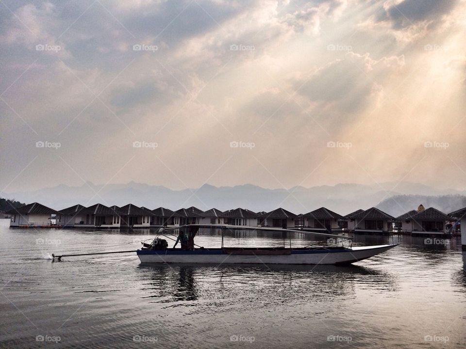 A boat in a lake with floating house resort background 