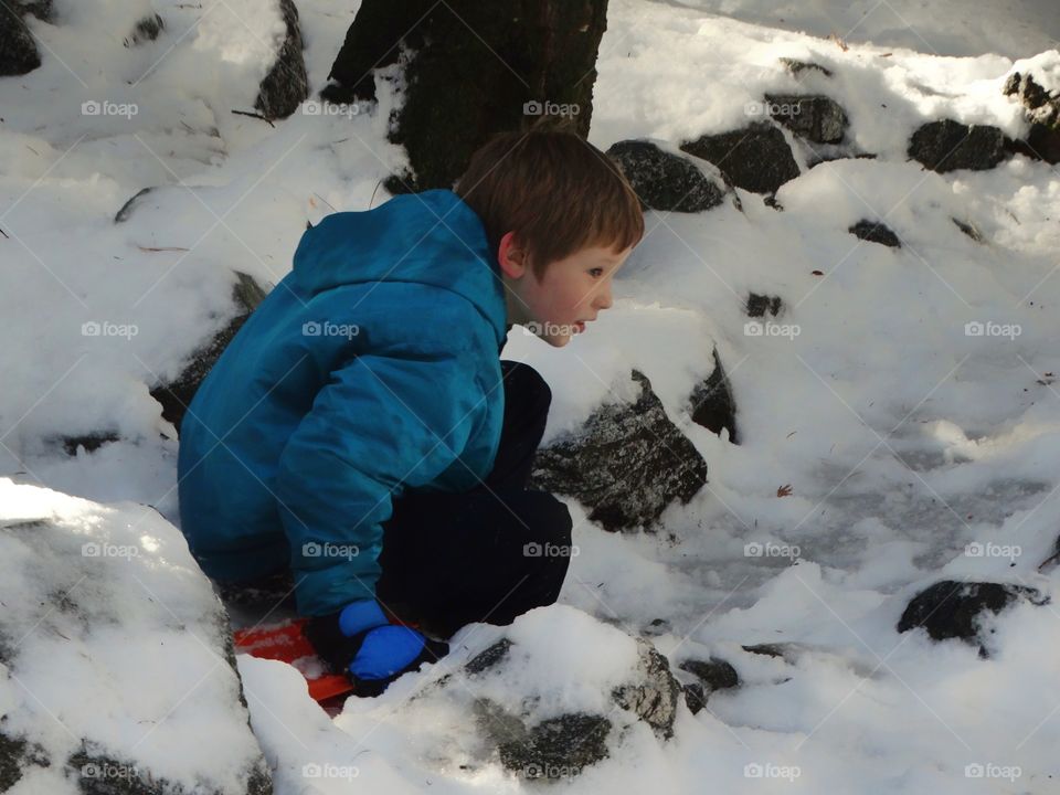 Boy Playing In The Snow