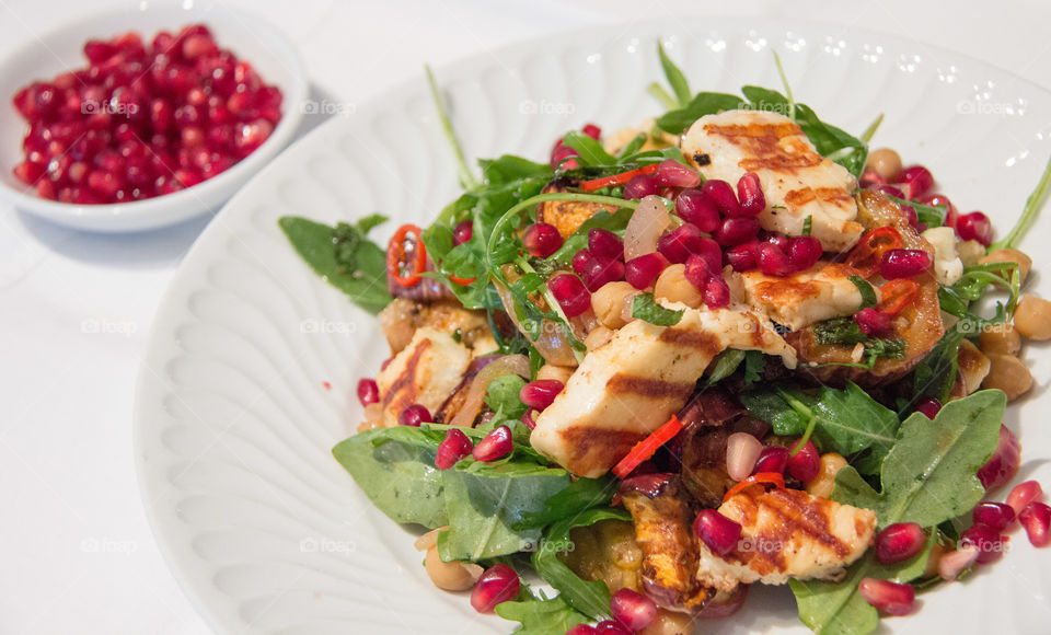 Grilled halloumi and chick pea salad with pomegranate seeds 