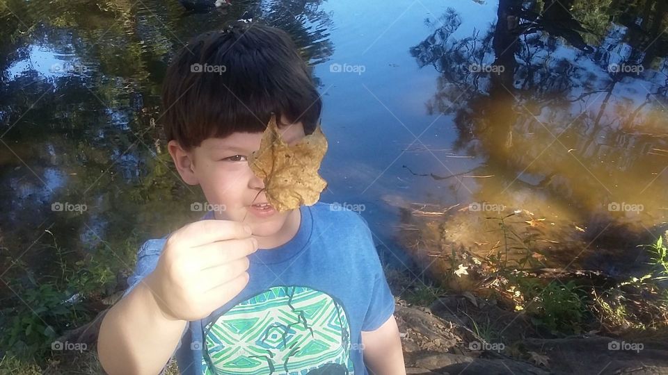 Boy with leaf in park