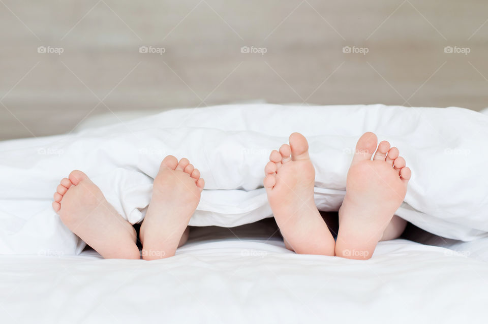 children's legs in the bed