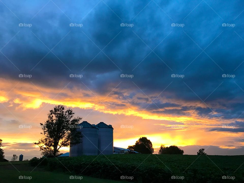 Country sunrise. 
#sunrise #farm #clouds #sky #trees #silos #landscape #countryside #cloudscape #nature 