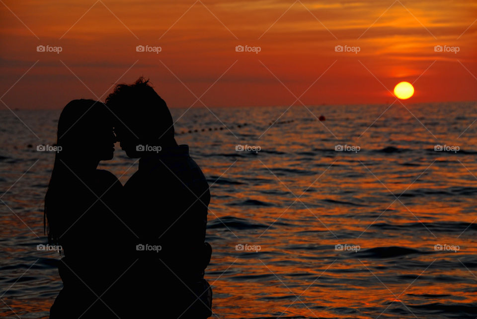 Silhouette of couple bonding at sunset
