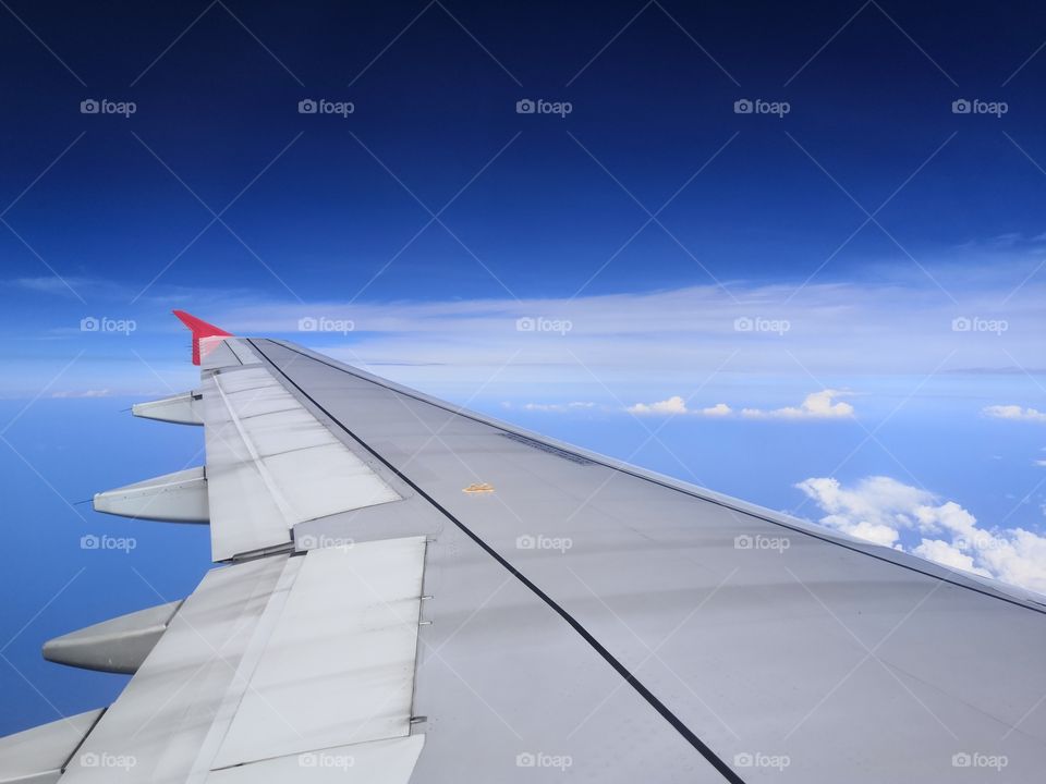 The wing of aeroplane with blue sky