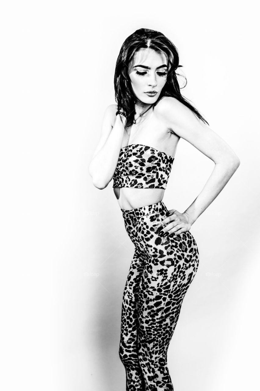 Black and white image of girl in 1960s style leopard print outfit