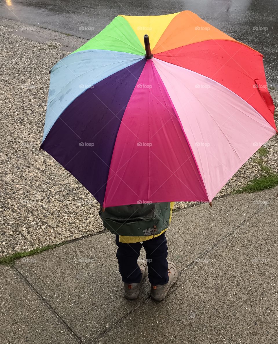 Having fun in the rain with a colourful umbrella