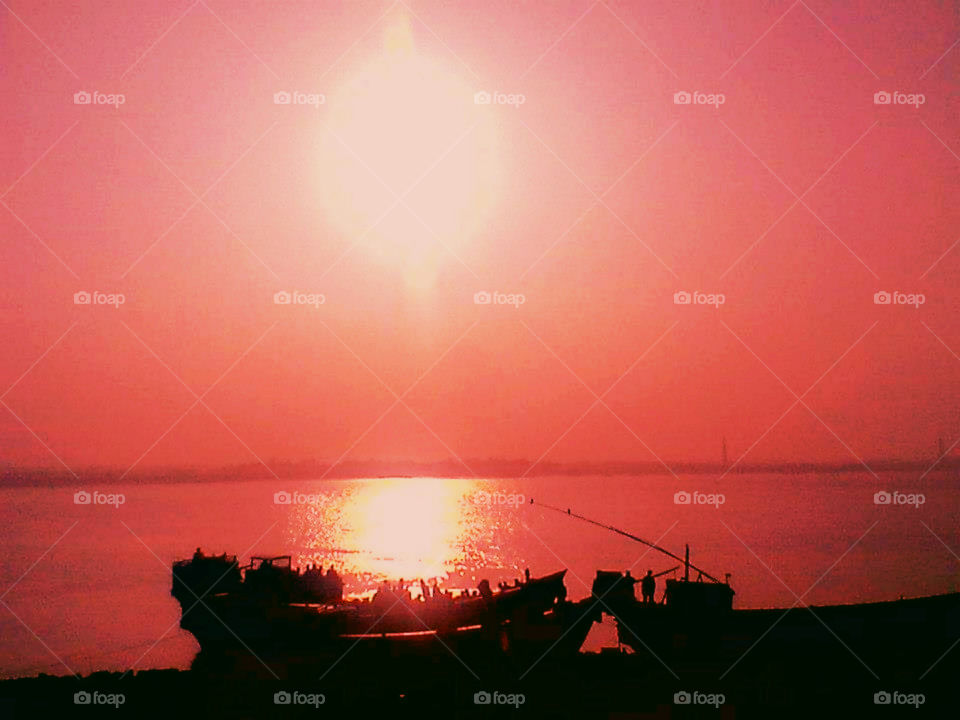 Amazing sunset view captured.Passengers waiting in the boat .Silhouette.