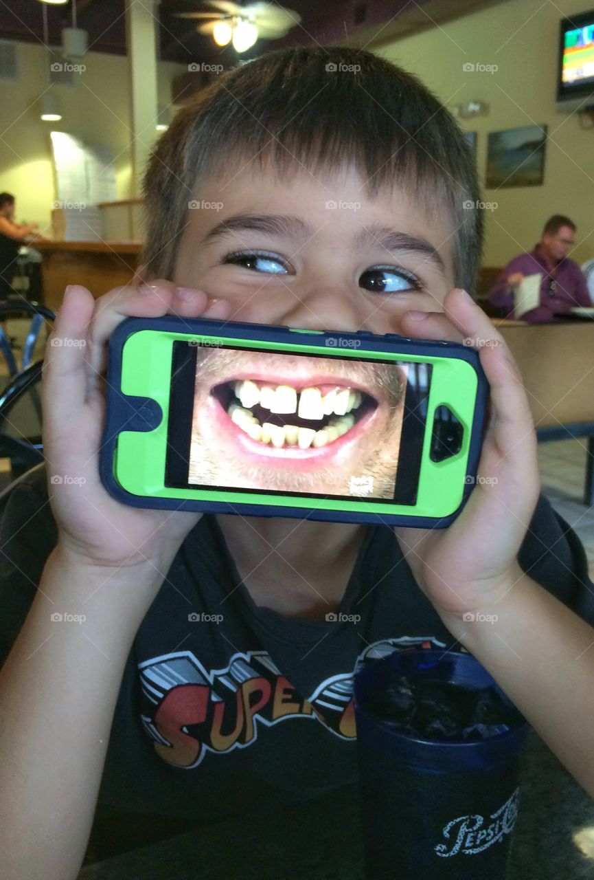 Close-up of boy holding smartphone