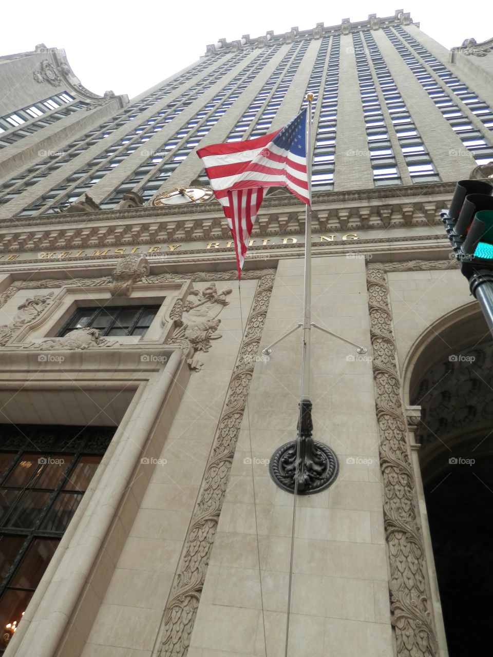 United States Stars and Stripes flag flaps at skyscraper basement 