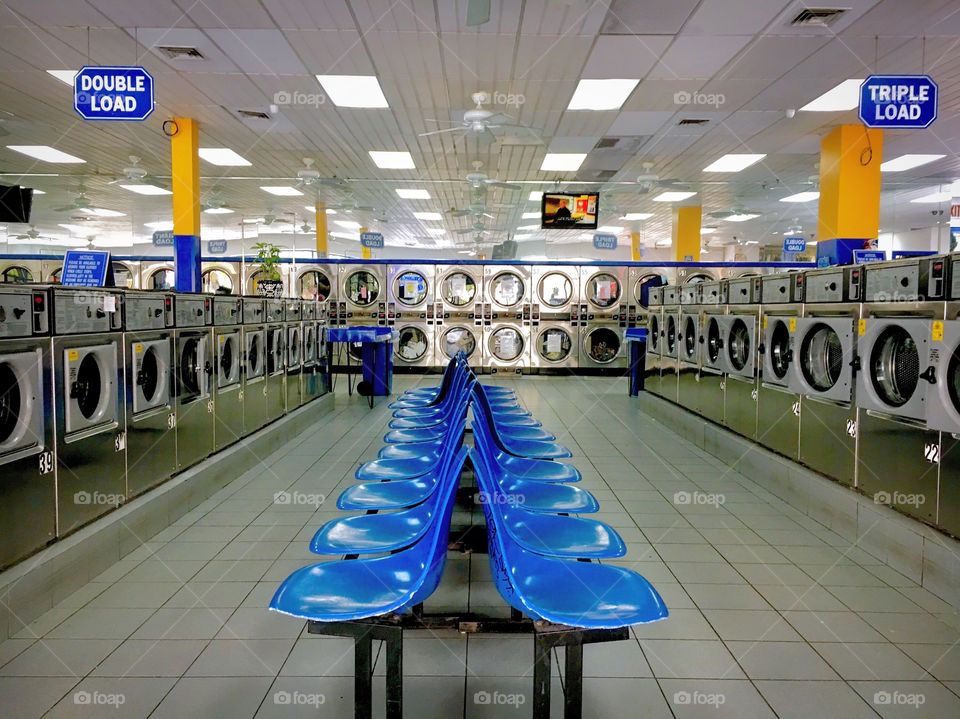 Large and Bright Laundromat with Blue Seats in Queens, New York City in 2017