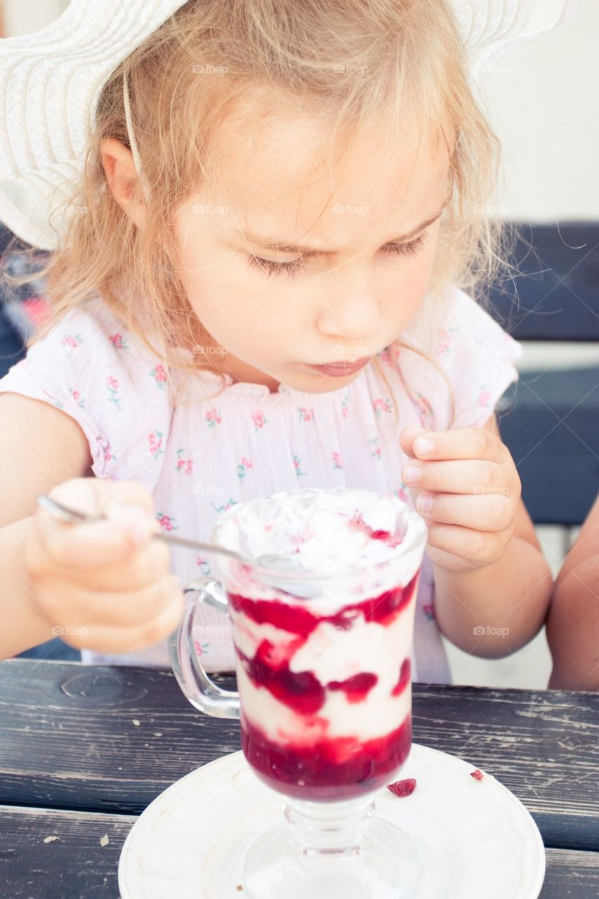 Girl eating big ice cream