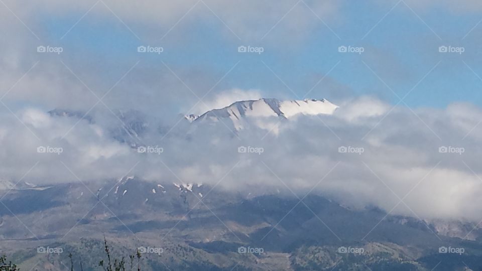 Mt. Saint Helens. Peaking through clouds is Mt. Saint Helens.