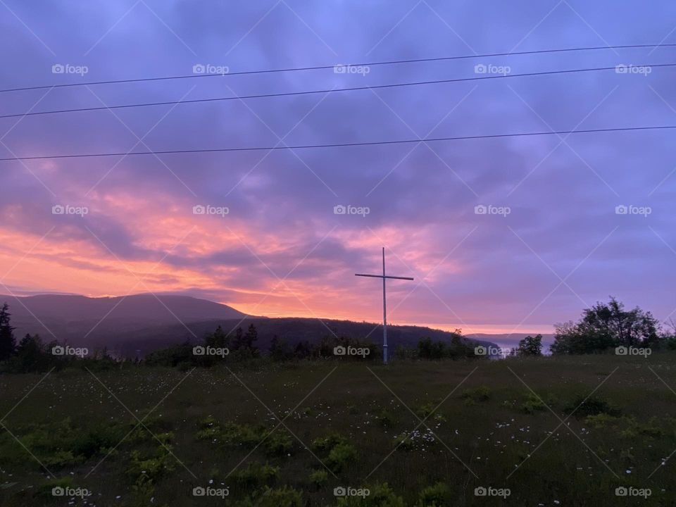 Sunset cross on a hill