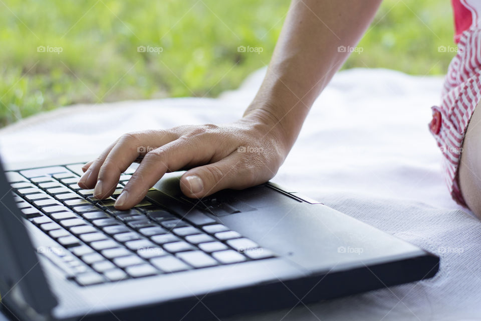 Woman's hand on laptop keyboard 