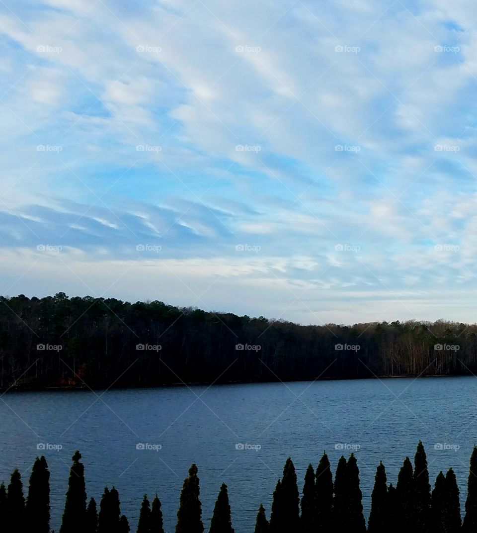 striated clouds over lake