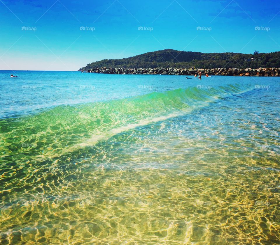 The clear water at the beach breaking wave 