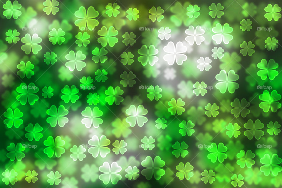 Green four leaf bokeh effect.Luck logo