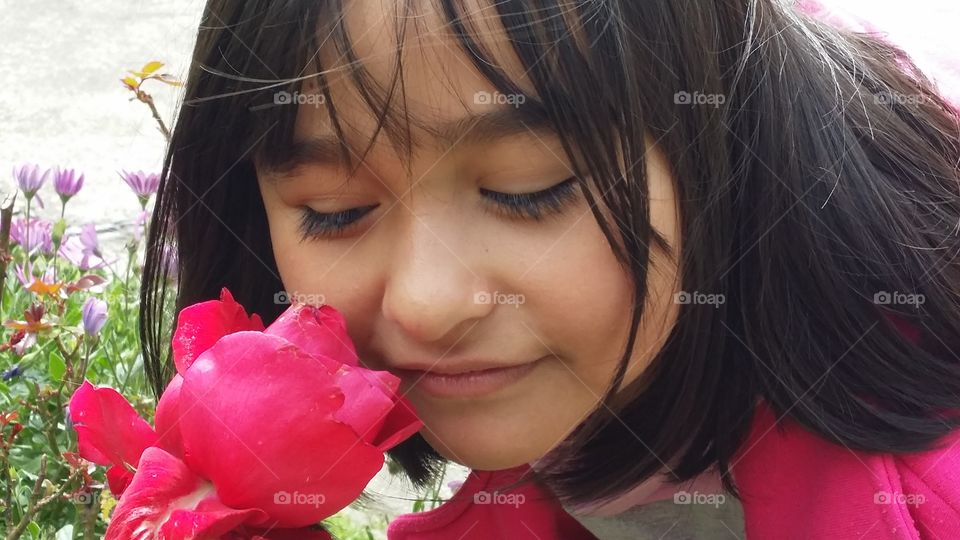 Little Yelenita smells flowers