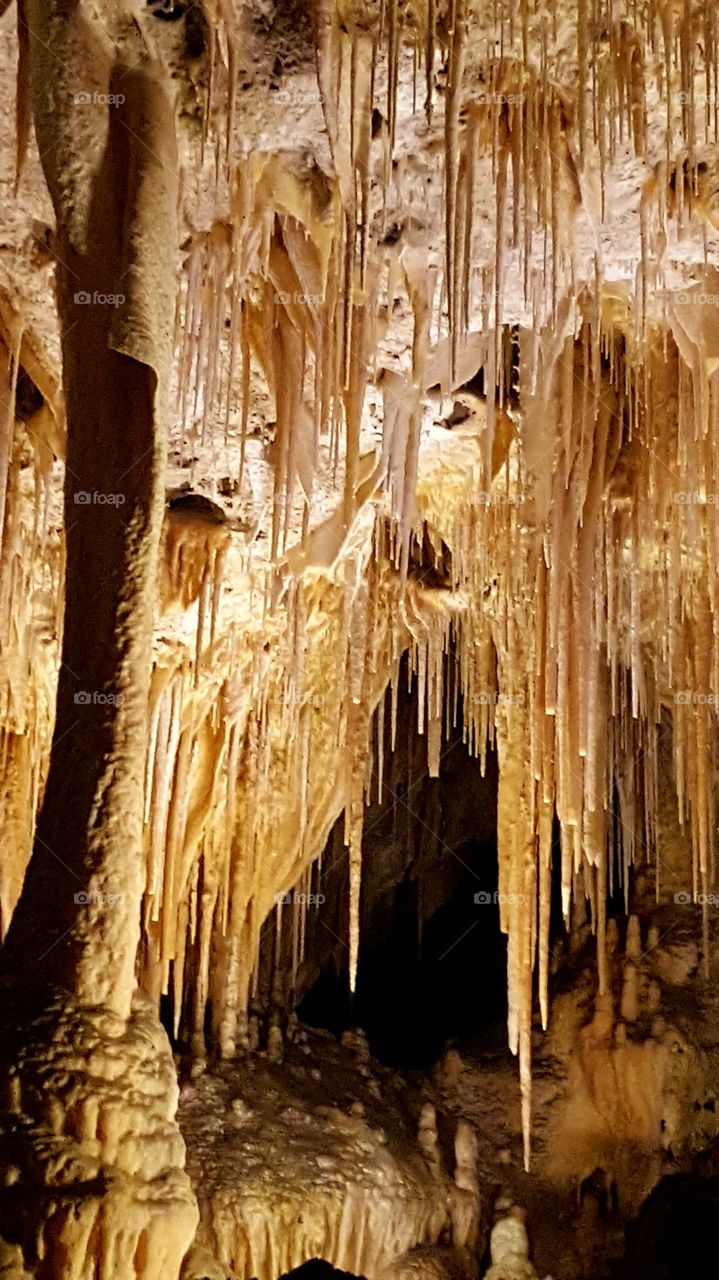 Cavern stalactites gleaming gold