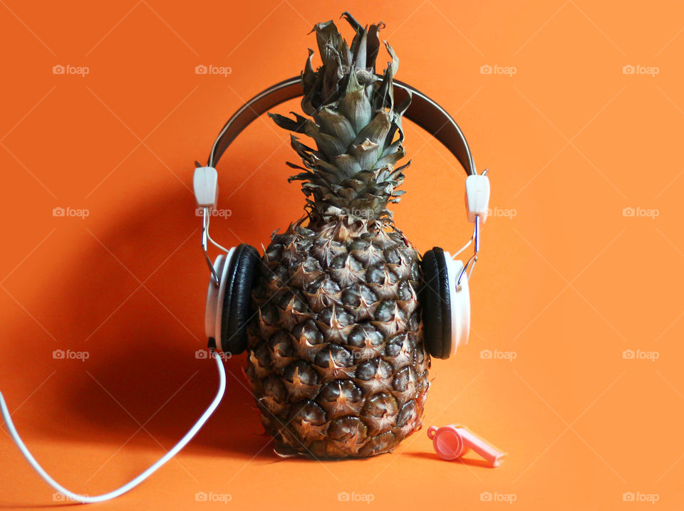Headphones on a pineapple fruit