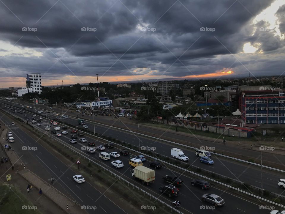 Transportation Cloud Road mode of transportation Architecture City sky car highway motor vehicle high angle view street built structure building exterior Traffic Nature dusk sunset freeway Dramatic sky