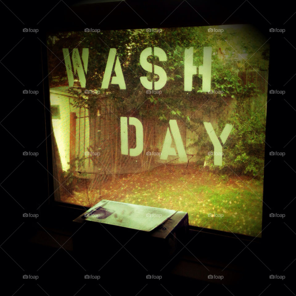 A window looking out from a laundry room.