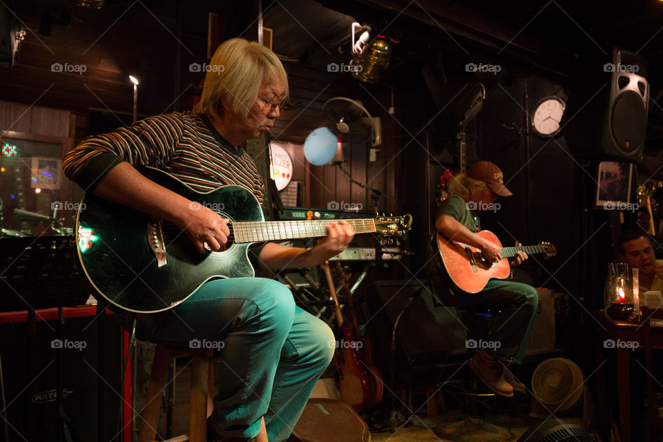 Musician playing Guitar in the club