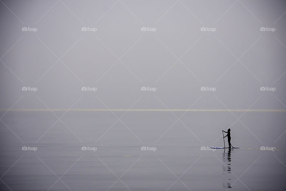 Tourists on surf boards in the sea at Prachuap Bay in Thailand.