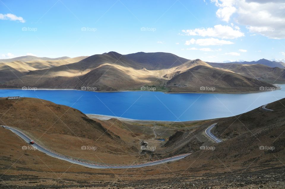 Winding road at lakeshore in Tibet