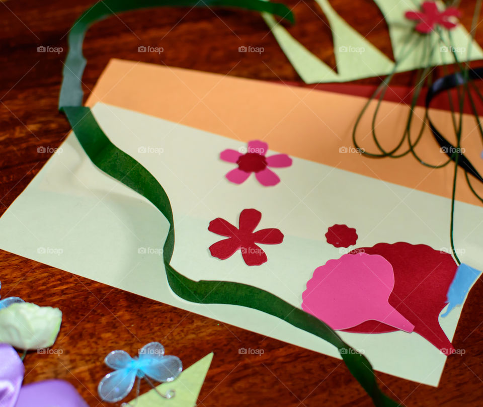 Cut out paper shapes, ribbon, different texture paper, wire and  ribbon arts and craft supplies background 