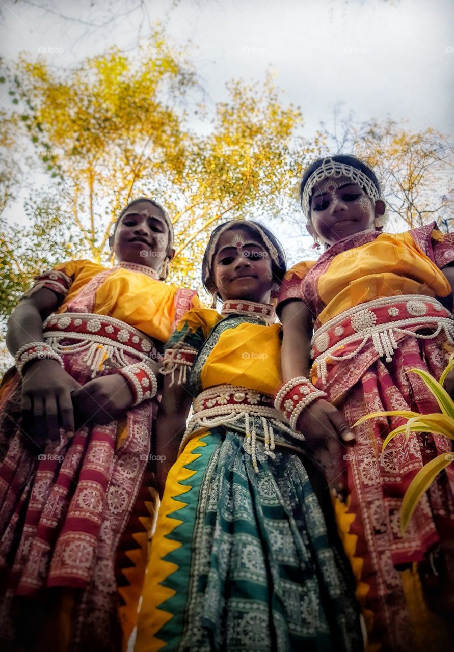 Happy girls together in their traditional colorful outfit for a traditional dance performance.