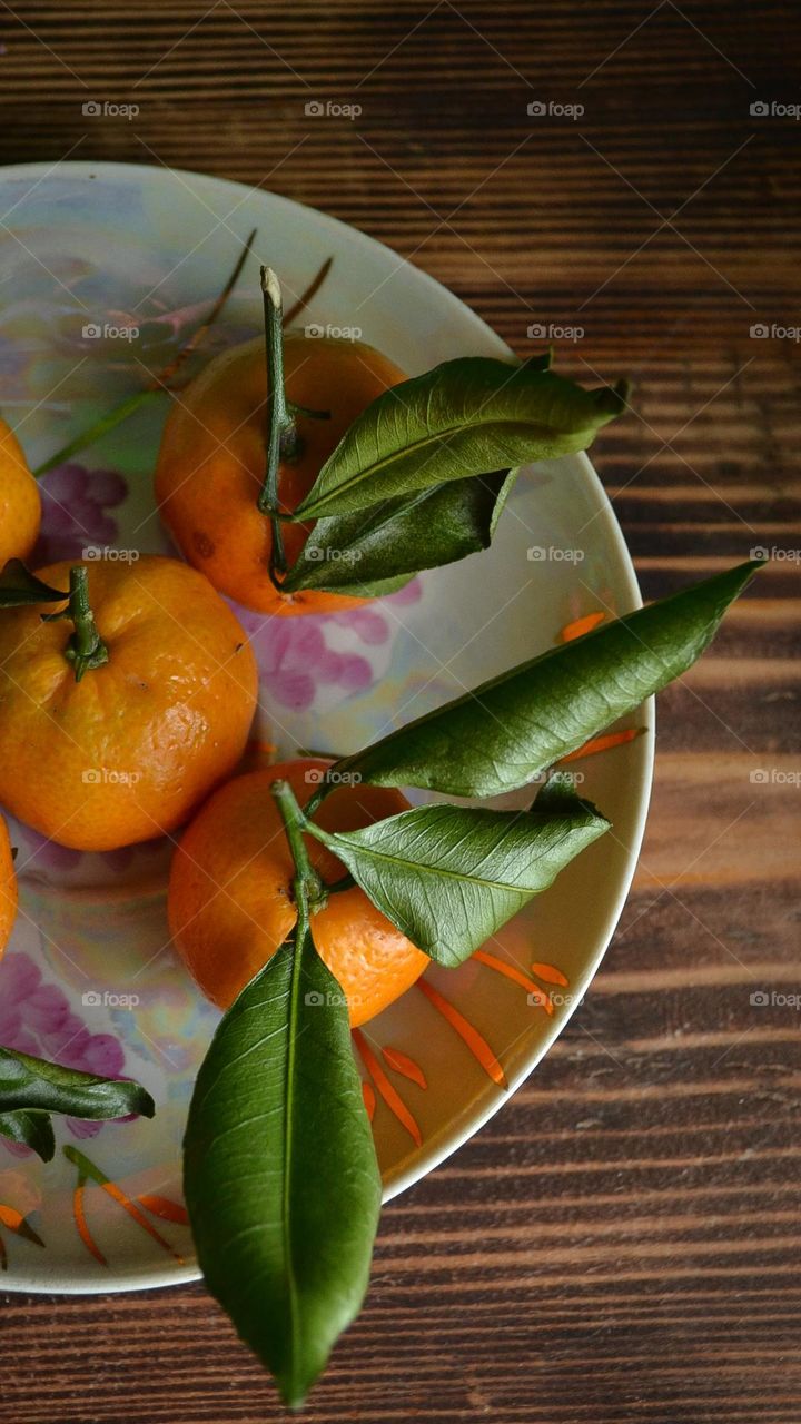 Orange tangerines on a saucer