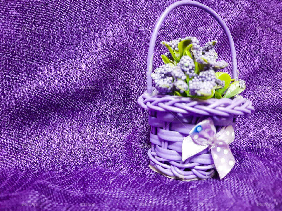 A purple flower basket on a purple background