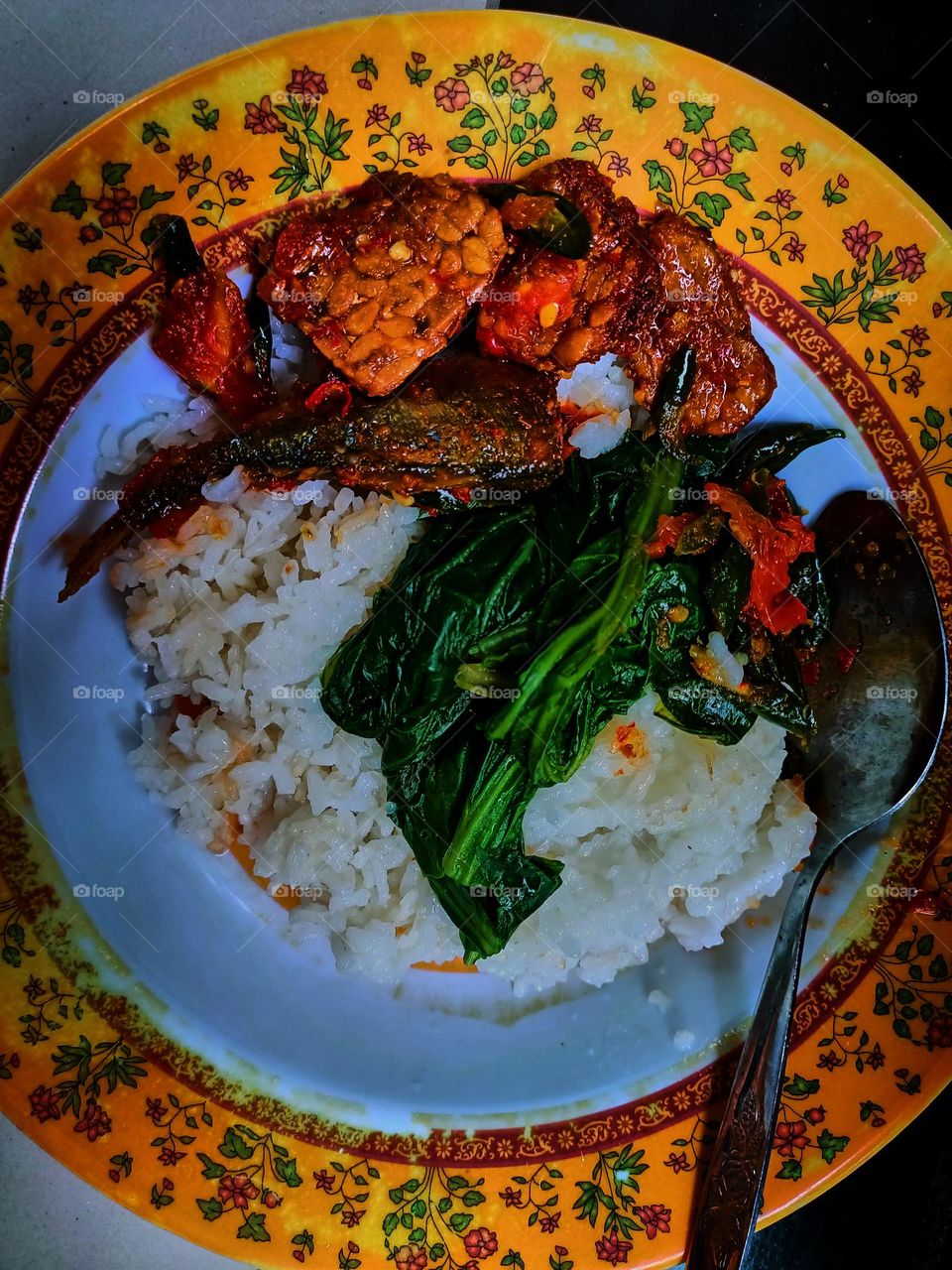 Fried fish and rice, Indonesian traditional home cooking. Local food. Flat lay top down overhead view