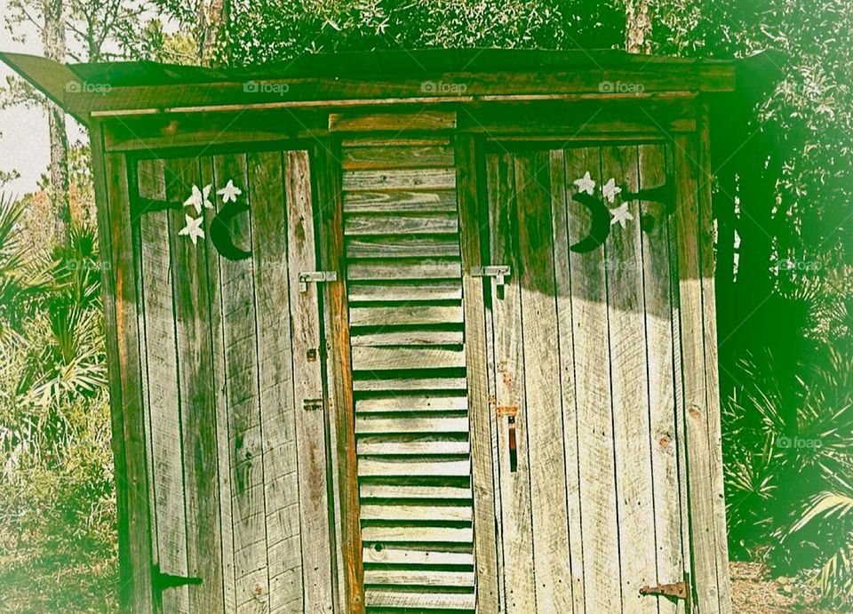 Vintage fancy wooden outhouse.