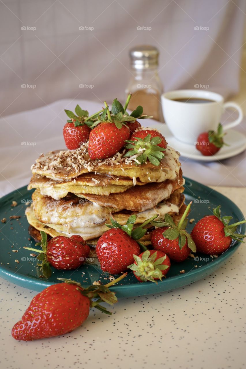 Pancakes with strawberry and cup of coffee 