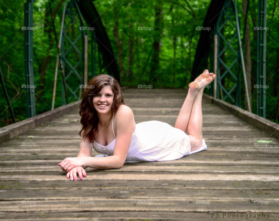 girl on bridge. Beautiful girl pose on secluded bridge
