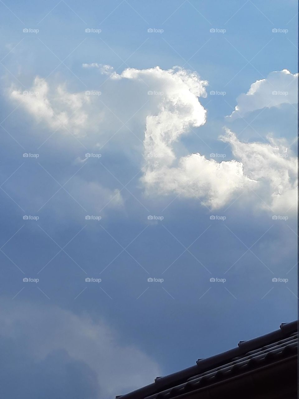 white clouds on blue sky on sunny day