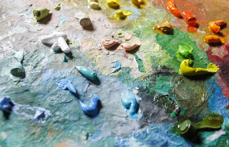 Colorful oil paint on a palette, close up