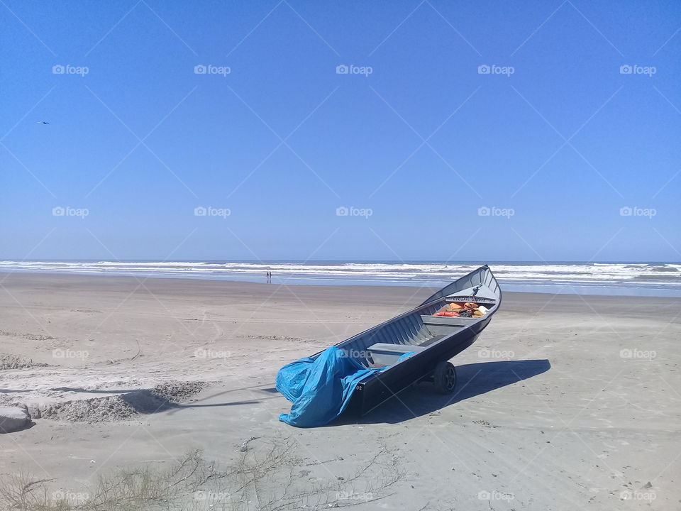 Beautiful view on the beach.  Autumn in Brasil....but the day was very hot. There is a fishing canoe on the sand